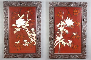 A pair of Japanese lacquered floral panels decorated flowers and butterflies contained in a hardwood frames 73cm x 48cm 