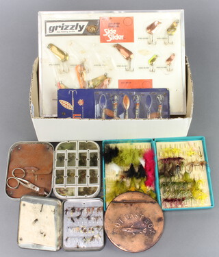 Two vintage trade cards with fishing lures, a Wheatley 12 window fly box, a Loch Leven trout fly box, a fly box and a copper cast case 