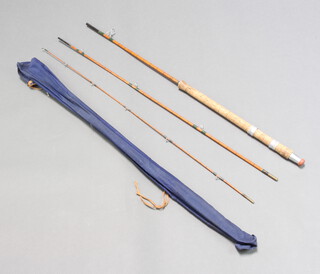 A vintage 9' three piece split cane spinning fishing rod in blue cloth bag 