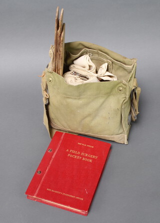 A Field Surgery pocket book 1962 and a gas mask case containing splint, dressings etc 