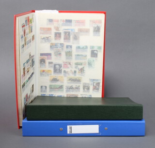 A red stock book of mint and used American stamps, an album of GB, Commonwealth and American stamps, ring bound folder containing various loose stamps 