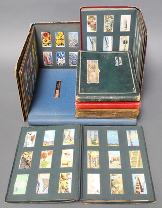An album containing Kensitas silk cigarette cards together with 6 albums of cigarette cards including Players, Wills, 