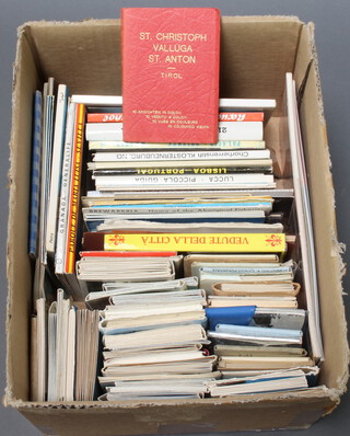A box containing a collection of coloured Continental postcards 