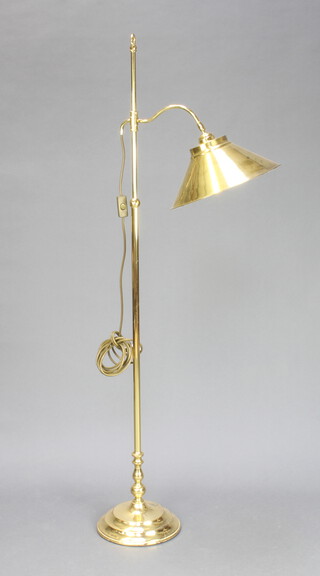 A Victorian style brass adjustable standard lamp raised on a circular foot 142cm h x 26cm diam. (some corrosion and pitting to the base in places)