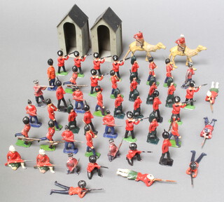 A large collection of Britains lead guardsmen and highlanders with two pressed metal sentry boxes and two camel corps figures