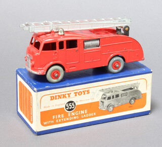 Dinky, a 555 red Fire Engine with extending ladder - boxed in blue with orange label.