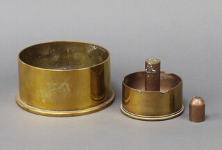 A Trench Art ashtray formed from a 4.5" shell together with a Trench Art cigar lighter/ashtray formed from a 1945 25lb shell case 