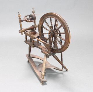 A 19th/20th Century turned beech spinning wheel 71cm h x 61cm w 