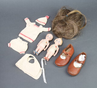 S Hancock & Sons of Staffordshire, 2 First World War bisque porcelain dolls - boy wearing a Victoria Cross, the girl wearing a Red Cross 14cm, together with 2 babies leather shoes etc  