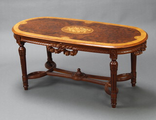 An Empire style oval figured walnut and crossbanded occasional table, raised on turned and flute supports with tracery stretcher 52cm h x 115cm w x 53cm d (some water marks to the top) 