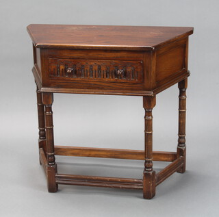 A carved oak credence table fitted a drawer with arcaded decoration on turned and block supports 76cm h x 84cm w x 41cm d 