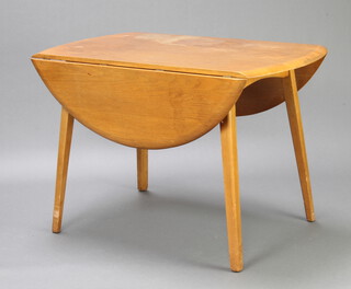 An Ercol style light elm kitchen drop flap dining table raised on turned supports 75cm h x 113cm w x 64cm (when closed)