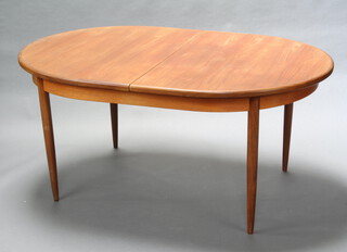 A mid Century G-Plan teak oval extending dining table raised on turned supports with concealed extra leaf 73cm h x 163cm l x 112cm w (ring and water marks to the top) 