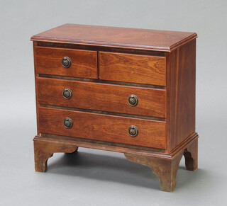 A Georgian style miniature mahogany chest of two short and three long drawers with ring drop handles, raised on bracket feet 51cm h x 53cm w x 27cm d (the top right hand ring handle is missing) 