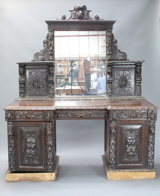 A Victorian carved oak inverted breakfront pedestal sideboard with rectangular plate mirror to the back flanked by shelves, heavily carved with mask decoration, the base fitted 3 drawers above cupboards enclosed by panelled doors 219cm h x 182cm w x 66cm d (sections of moulding missing to the base)