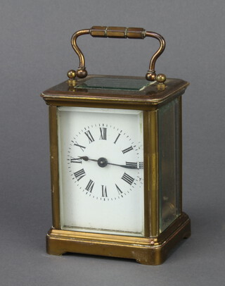 A 19th Century French 8 day carriage timepiece with enamelled dial and Roman numerals contained in a gilt metal case 8 1/2cm h x 6.5cm w x 6cm 