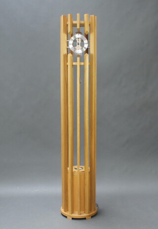 Charlie Turner, "The Manhattan" a stylish 20th Century striking skeleton longcase clock with silvered dial, Roman numerals, contained in a light oak slatted case 188cm h x 33cm w, complete with key, weight and pendulum  