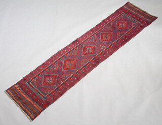 A red and green ground Meshwani runner with 5 stylised diamonds to the centre 260cm x 62cm 