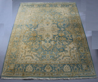 A light blue and cream ground Persian style machine made carpet with central medallion 365cm x 275cm 