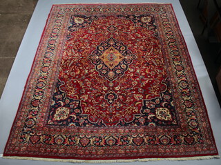 A red and blue ground Persian carpet with central medallion within a multi row border  380cm x 297cm 