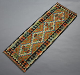 A blue, turquoise and white ground Chobi Kilim runner with 4 diamonds to the centre 188cm x 67cm 