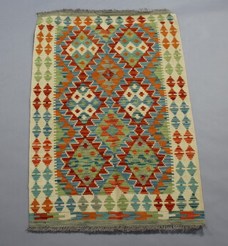 A cream, yellow and green Chobi Kilim rug with all over geometric design 126cm x 80cm 