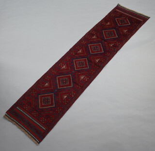 A red and blue ground Meshwani runner with 6 diamonds to the centre 258cm x 62cm 