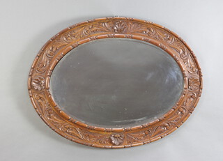 A Victorian oval bevelled plate wall mirror contained in a carved oak frame 68cm h x 92cm w 