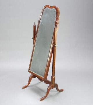 A Queen Anne style arched bevelled plate dressing mirror contained in a walnut swing frame 133cm h x 48cm w x 47cm d 