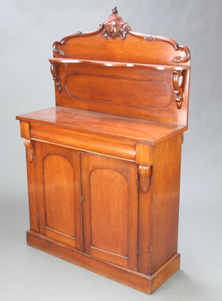 A Victorian mahogany chiffonier with raised back fitted a shelf, the base fitted a drawer above pair of cupboards enclosed by arched panelled doors 142cm h x 90cm w x 36cm d 