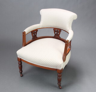 A Victorian carved walnut show frame tub back armchair upholstered in grey diamond patterned material raised on turned supports 72cm h x 57cm w x 56cm d (seat 42cm x 44cm) 