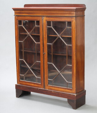An Edwardian inlaid mahogany bookcase with raised back fitted adjustable shelves enclosed by astragal glazed panelled doors on bracket feet 118cm h x 90cm w x 24cm d (formerly a bureau bookcase top)  