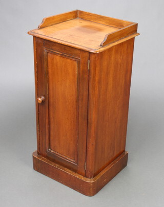 A Victorian mahogany pot cupboard with 3/4 gallery and shelved interior enclosed by a panelled door, raised on a platform base 80cm h x 40cm w x 34cm d 