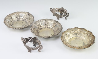 A pair of Victorian repousse silver pierced bon bon dishes, Chester 1897, a single ditto and 2 condiment holders, 200 grams 