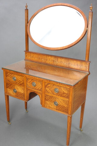 An Edwardian Hepplewhite style inlaid satinwood dressing table with oval bevelled plate mirror above 1 short and 4 long drawers, raised on square tapered supports with brass caps and casters (1 missing) 158cm h x 93cm w x 46cm d 