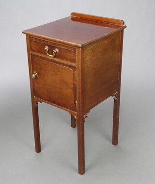 Warings, an Edwardian mahogany Georgian style bedside cabinet with raised back fitted a drawer above panelled door, raised on square supports 78cm h x 38cm w x 39cm d 