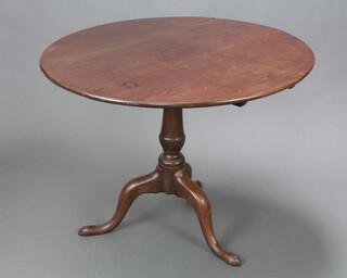 A Georgian circular mahogany snap top tea table raised on a turned column and tripod base 66cm h x 88cm diam. 