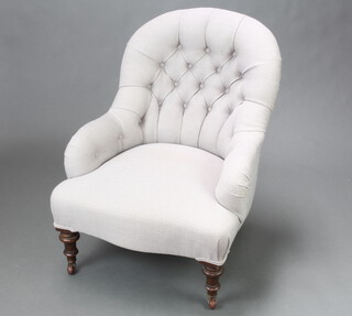 A Victorian tub back armchair upholstered in grey buttoned material, raised on turned supports 84cm h x 65cm w x 61cm d (seat 39cm x 43cm) 