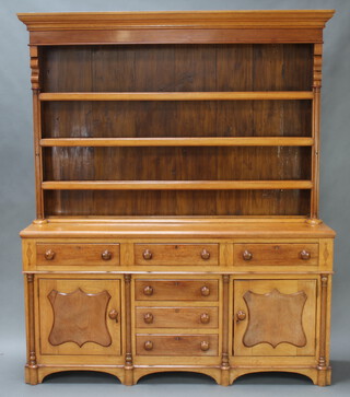 A reproduction 18th Century style light oak dresser, the raised back with moulded cornice, fitted 3 shelves flanked by columns, the base fitted 6 drawers flanked by panelled doors 220cm h x 185cm w x 49cm 