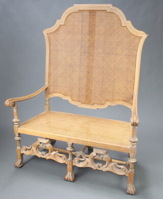 A reproduction 17th Century Italian carved limewood show frame high back sofa with woven cane seat and back, having a carved and pierced apron 143cm h x 108cm w x 57cm d (seat 89cm w x 35cm d)   