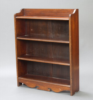 An Edwardian Art Nouveau oak bookcase with raised back fitted 4 shelves, having a shaped base 107cm h x 84cm w x 23cm d 