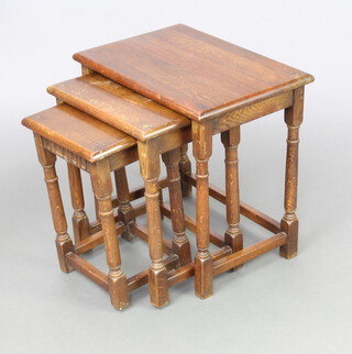 A nest of 3 rectangular oak interfitting coffee tables raised on turned and block supports 48cm h x 48cm w x 33cm d, 44cm x 38cm x 28cm and 40cm x 30cm x 25cm 