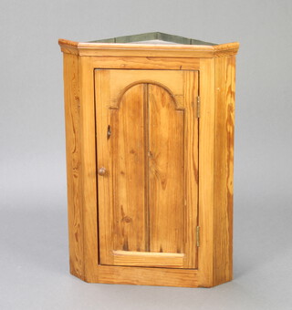 A Victorian style pine corner cabinet with arched panelled door and moulded cornice 63cm h x 44cm w x 30cm d
