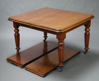 A Victorian mahogany extending dining table with 2 extra leaves, raised on turned and reeded supports 73cm h x 103cm w x 116cm l x 195cm when extended 