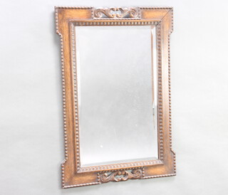 A 1930's rectangular bevelled plate wall mirror contained in a carved oak frame 84cm h x 57cm w 
