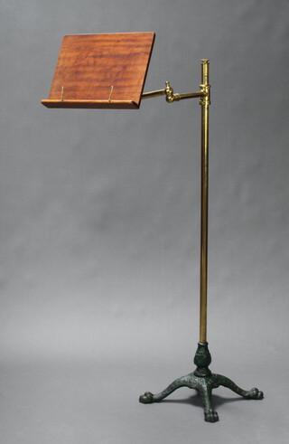 A Victorian mahogany brass and iron adjustable music stand, raised on paw feet 120cm h x 33cm w x 33cm d 