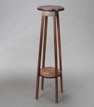 A 1930's circular oak 2 tier jardiniere stand raised on squared supports 100cm h x 26cm diam. 