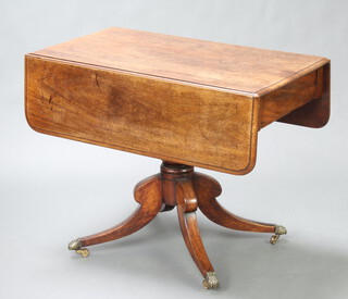 A Georgian mahogany pedestal pembroke table fitted a frieze drawer, raised on a turned column and tripod base ending in paw brass caps and casters 71cm h x 93cm w x 51cm when closed x 102cm when open 