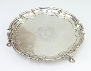 A George II silver card tray with Chippendale rim with engraved armorial, raised on hoof feet, London 1734, 226 grams, 15cm 
