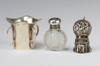 A silver 4 handled cup Birmingham 1911, 2 bottle tops and a silver mounted scent, weighable silver 44 grams